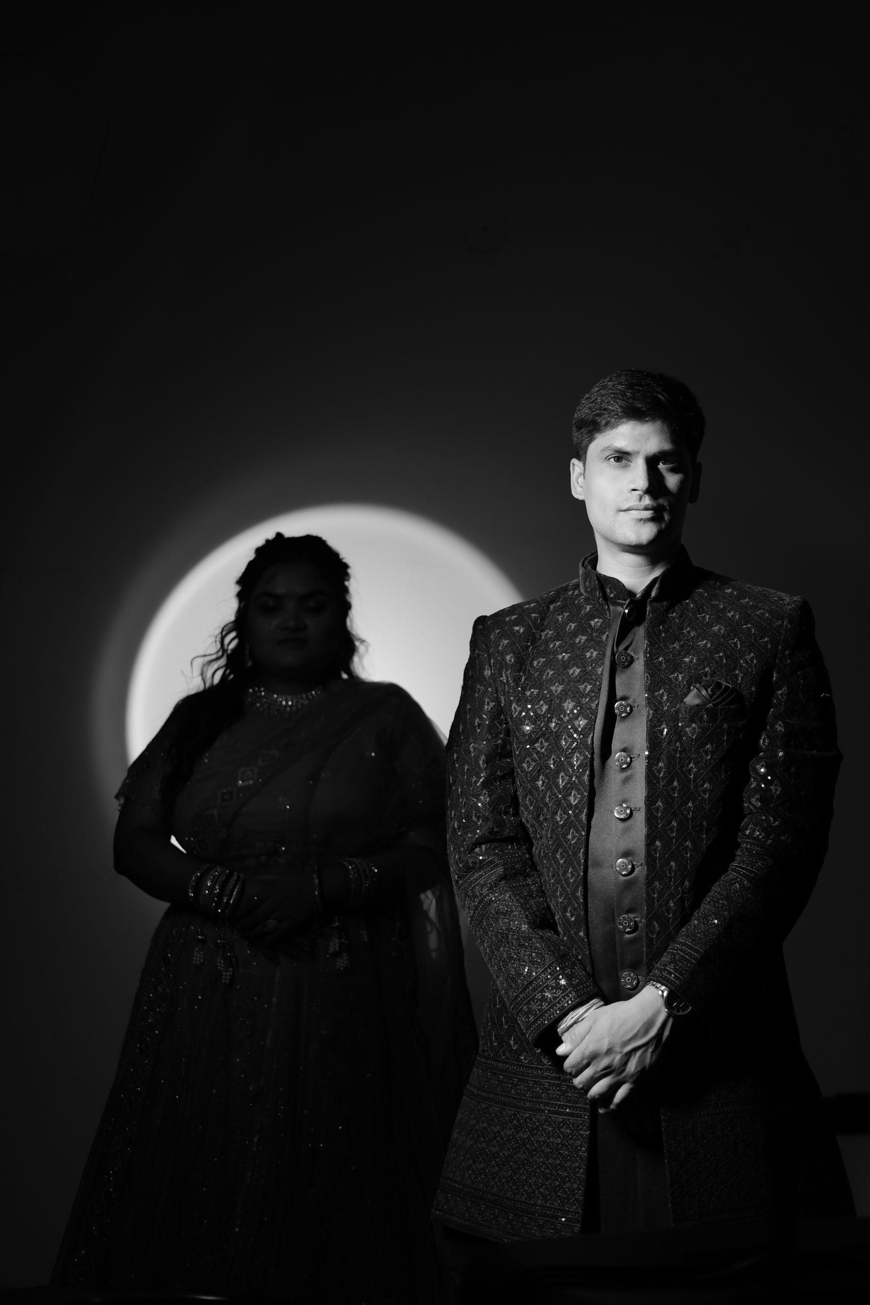Wedding couple standing together in an artistic black and white portrait