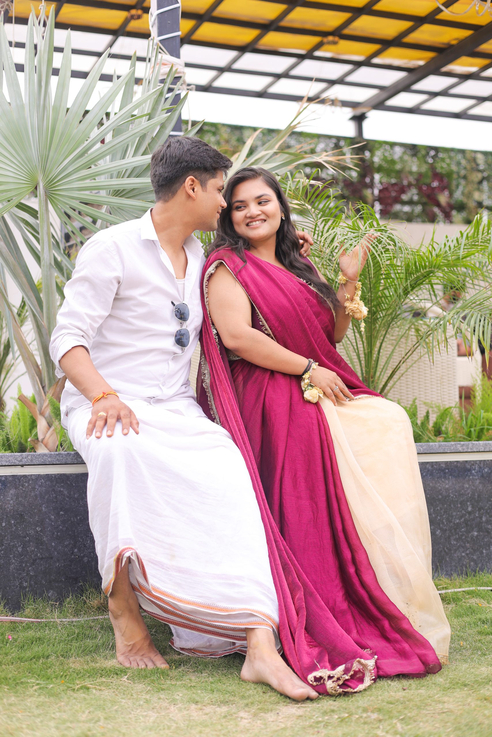 Couple posing outdoors in traditional Indian outfits during a pre-wedding photoshoot
