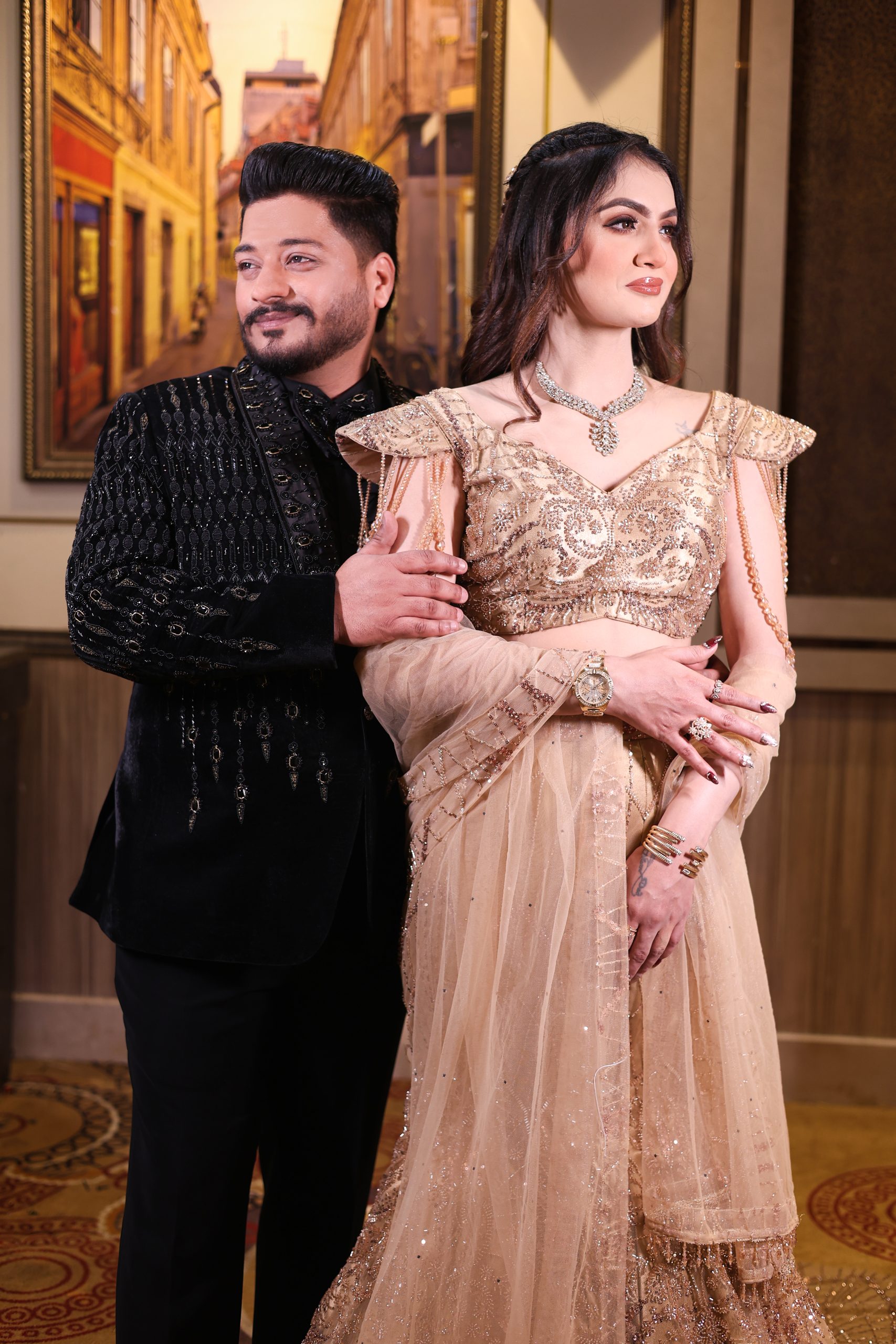 Bride and groom posing together in elegant wedding outfits