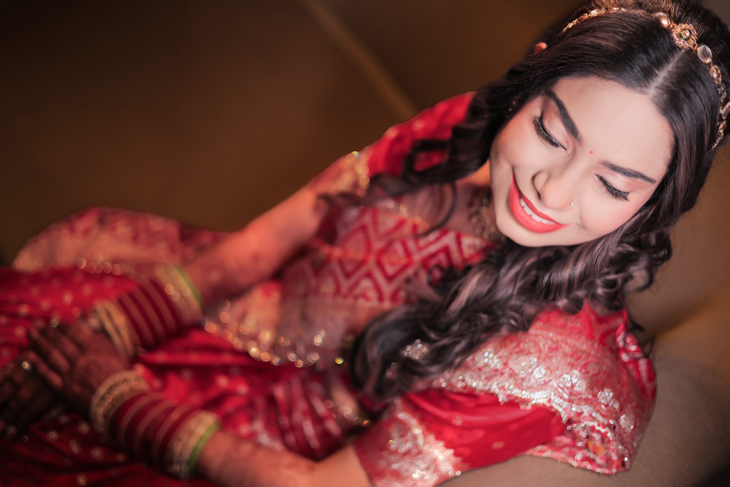 Bride posing in a red bridal outfit in a close-up photograph