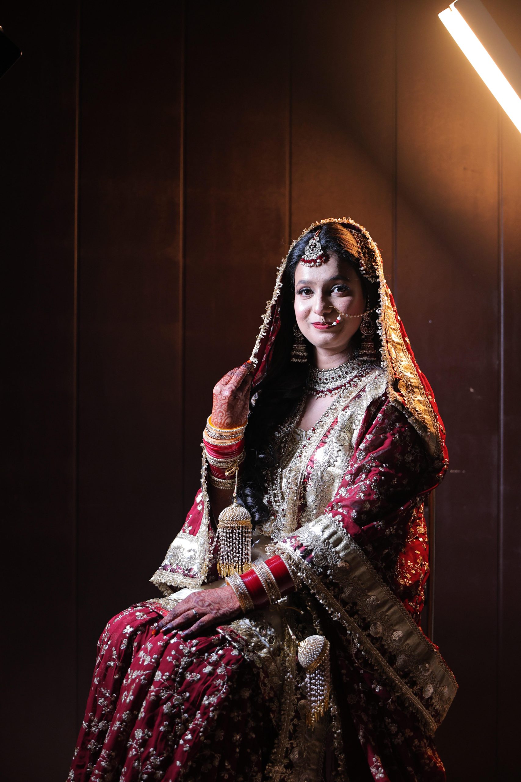 Bride wearing traditional wedding jewellery and bridal attire in a portrait