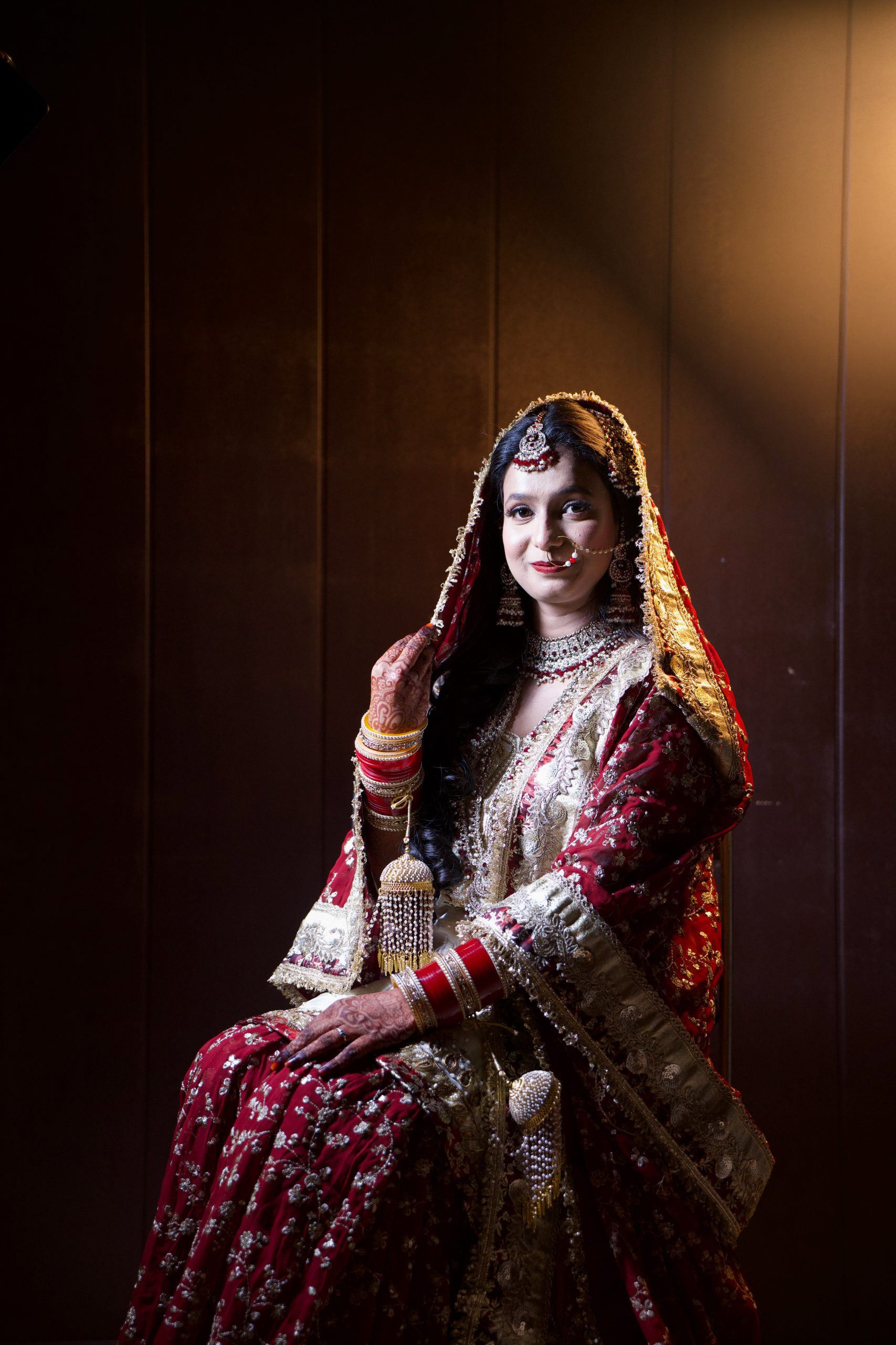 Bride in traditional bridal attire posing for a wedding portrait