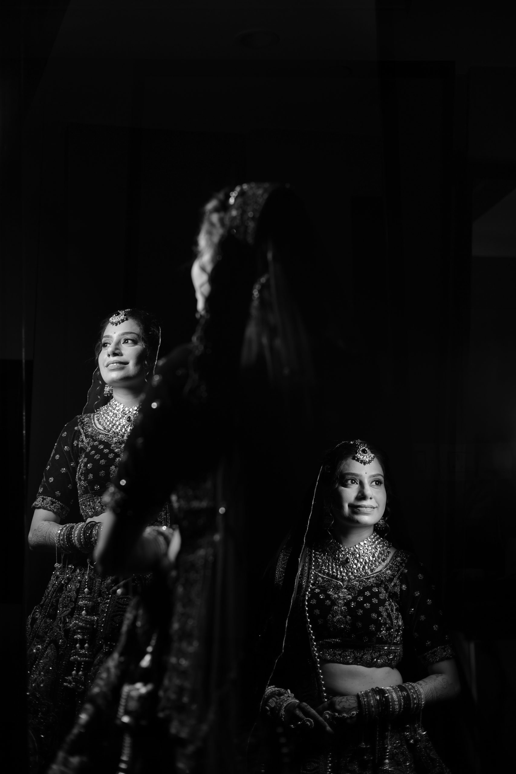 Artistic black and white wedding portrait featuring the bride and groom