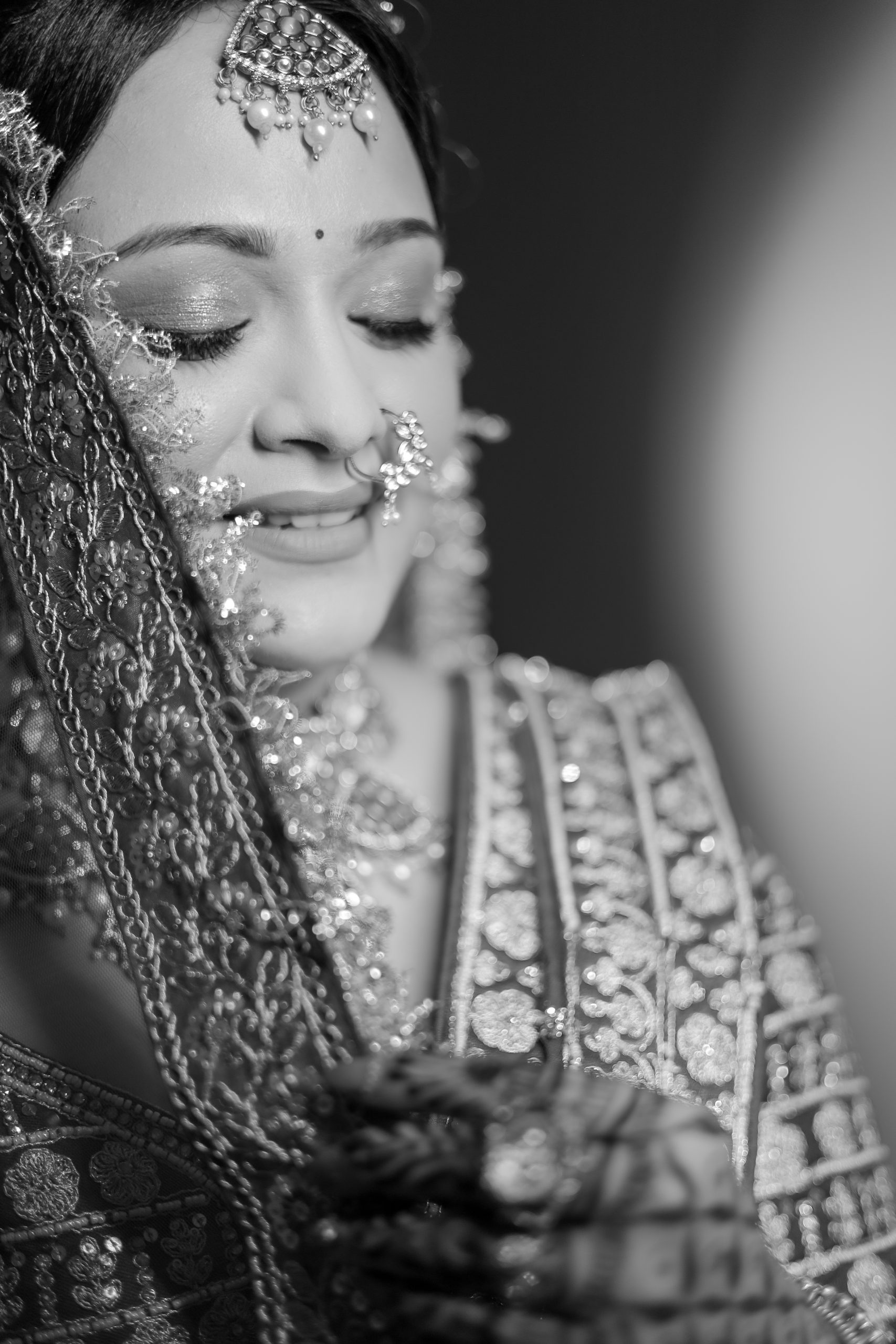 Black and white close-up portrait of a bride wearing traditional jewellery