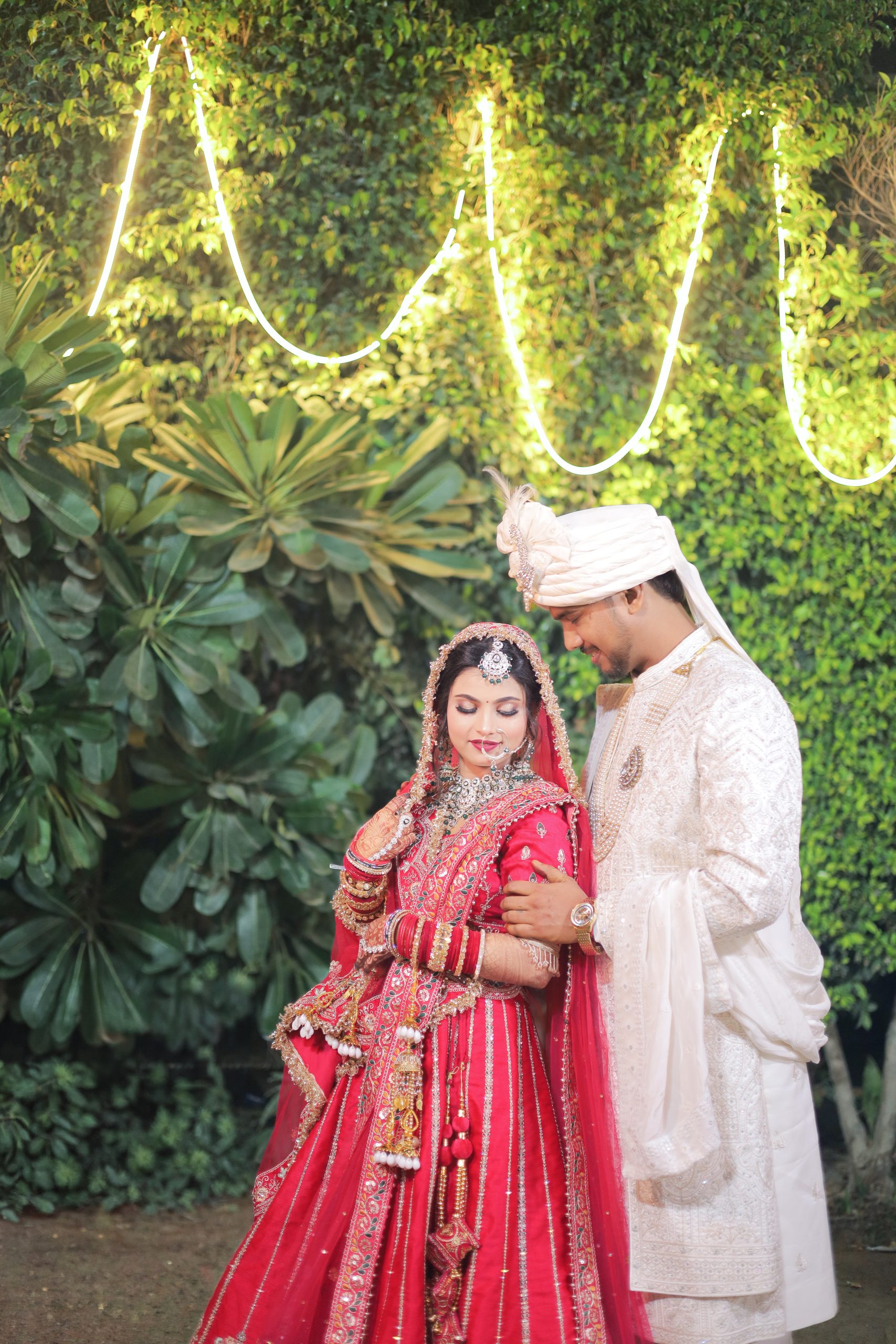 Bride and groom sitting together in a green garden